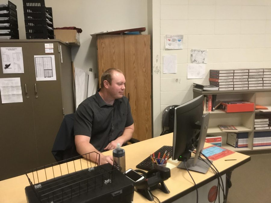 Coach Sundiquist working on his computer at his desk