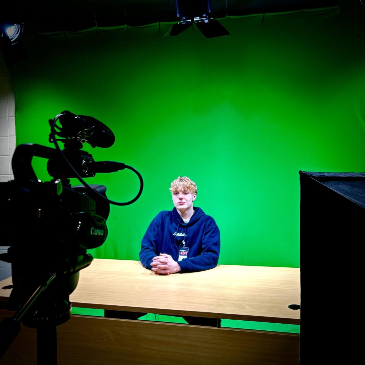 CRTV Student Xander Gause sitting in the green room. (Photo Credit: Colby Wilcox)